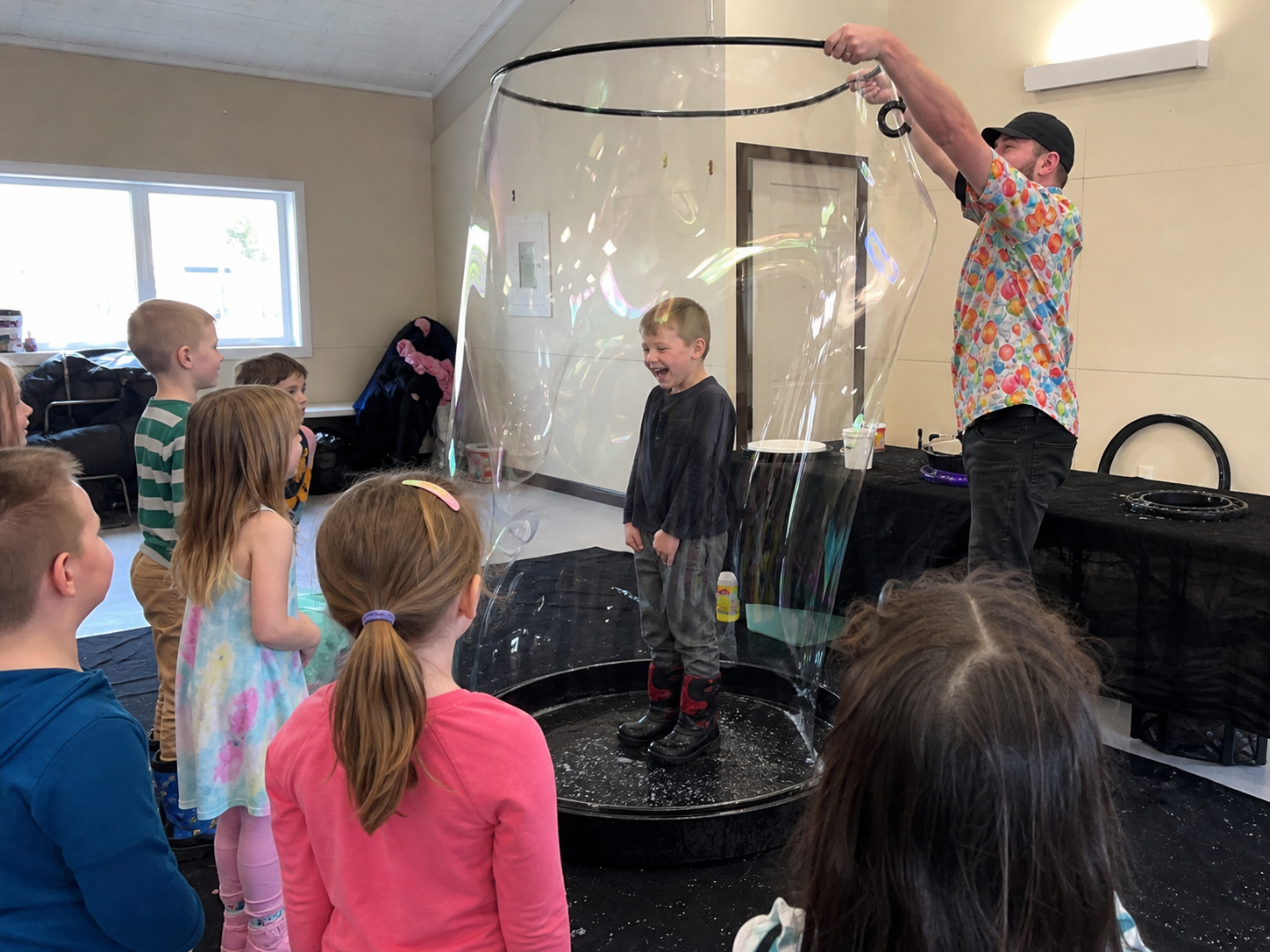 Child standing inside a giant bubble